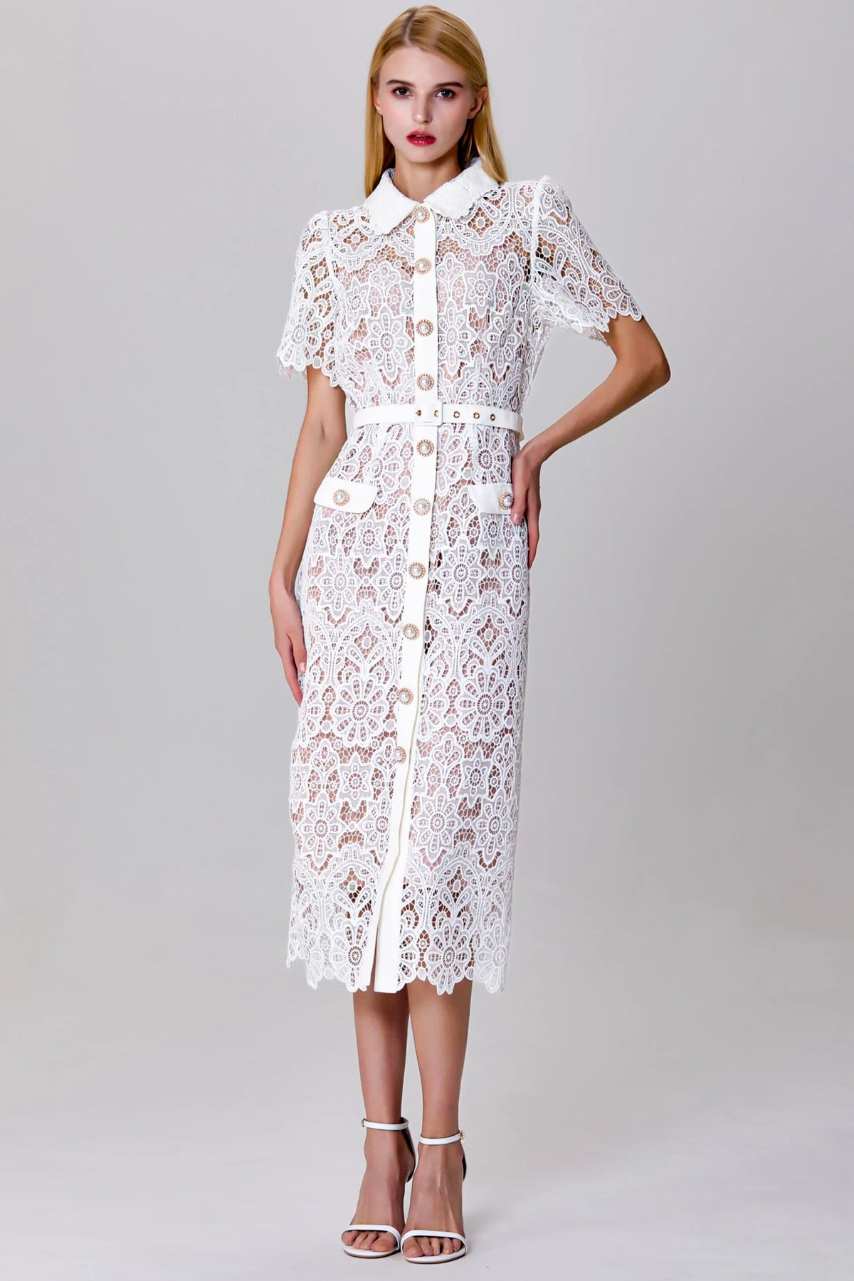 model wearing sheer white lace midi dress with gold buttons