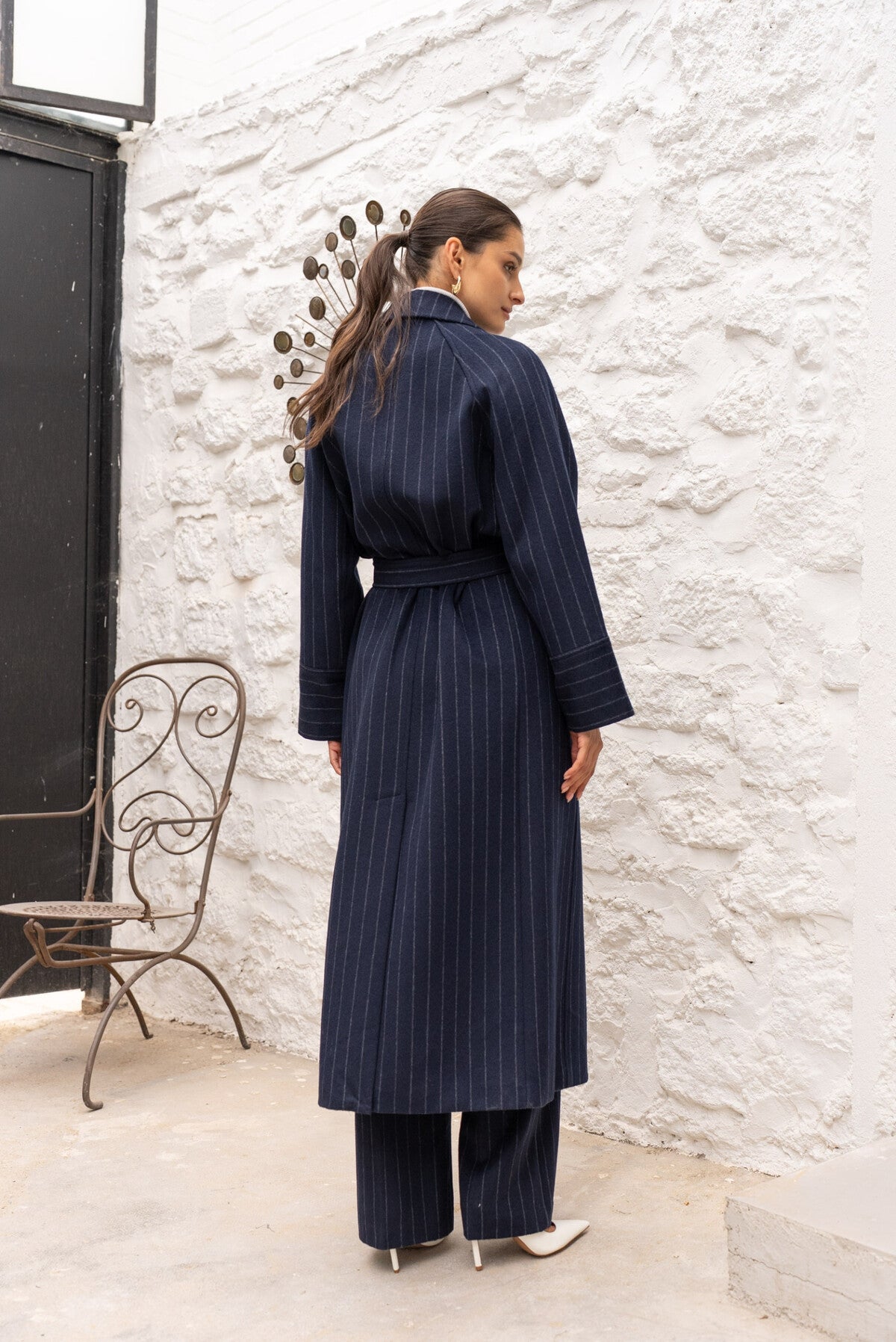 Back view of Amelia long wool coat highlighting tailored design and length.