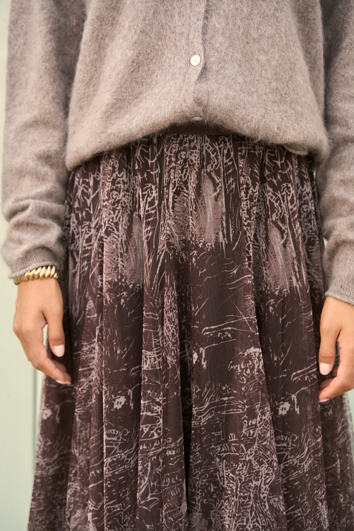 Brown A-line tulle midi skirt with pleated detailing and statement printed design