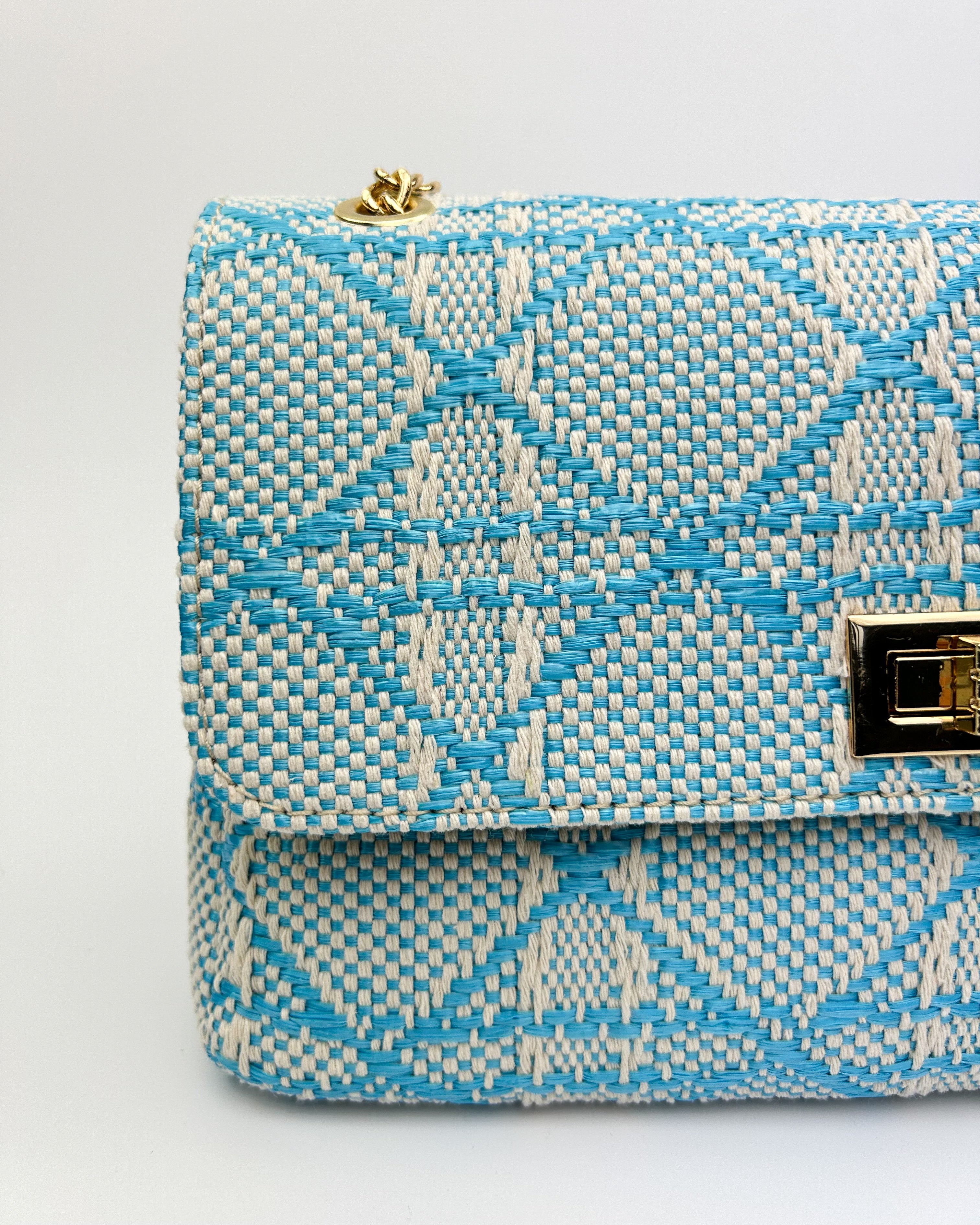 Close-up of Emma bag’s gold chain and leather strap detail
