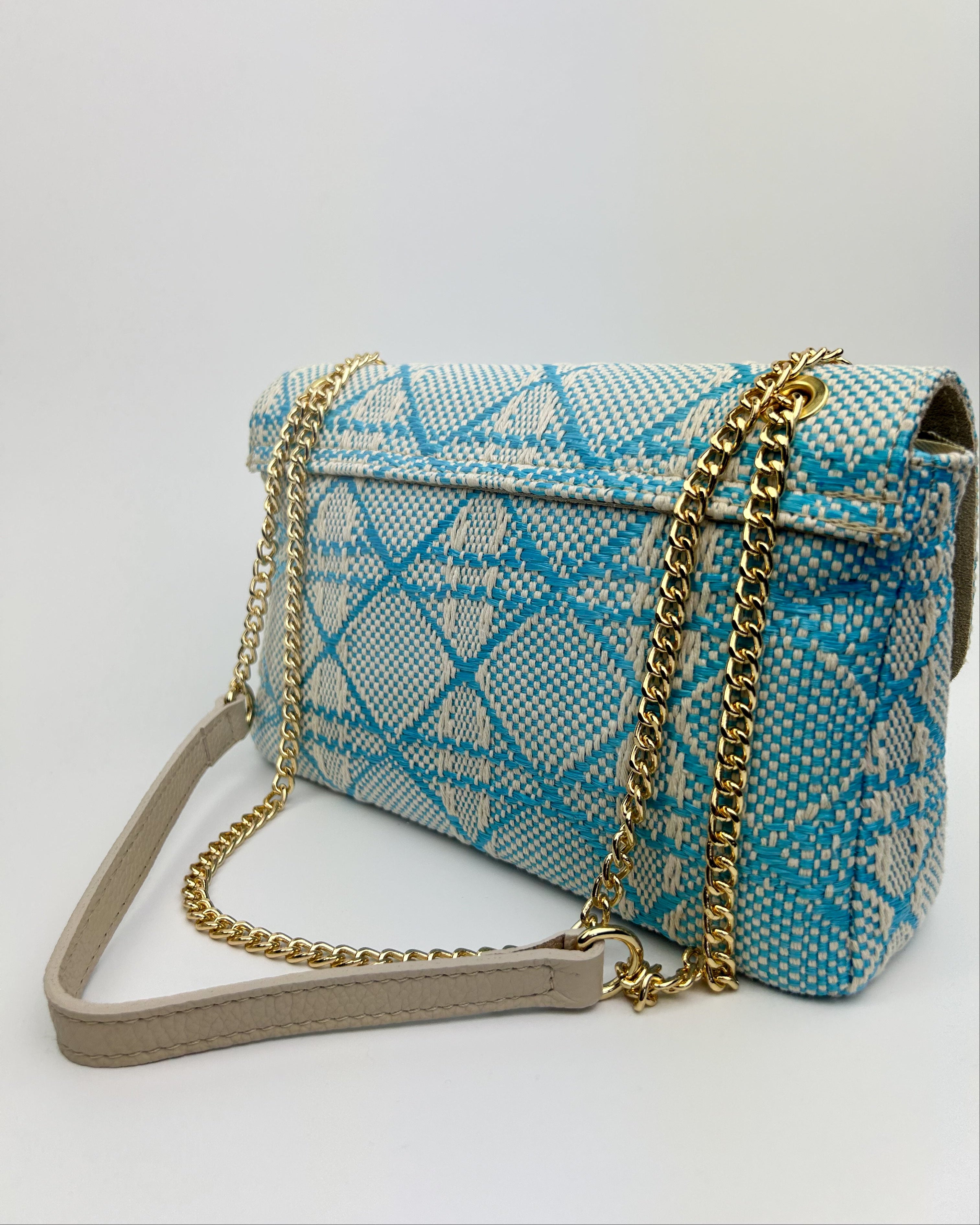 Side view of blue Emma bag with leather trim and long shoulder strap