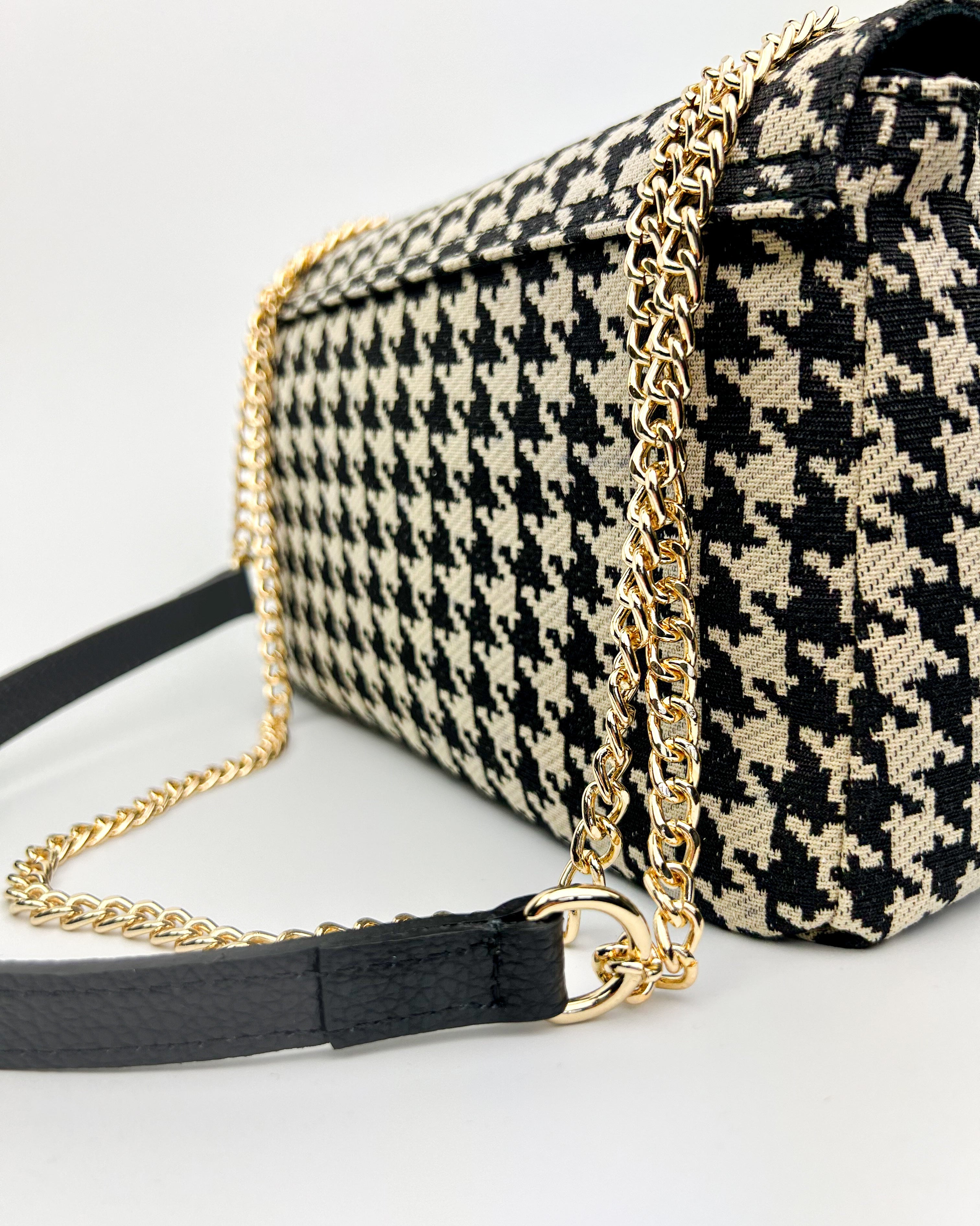 Detail of gold chain and leather strap on Emma patterned shoulder bag
