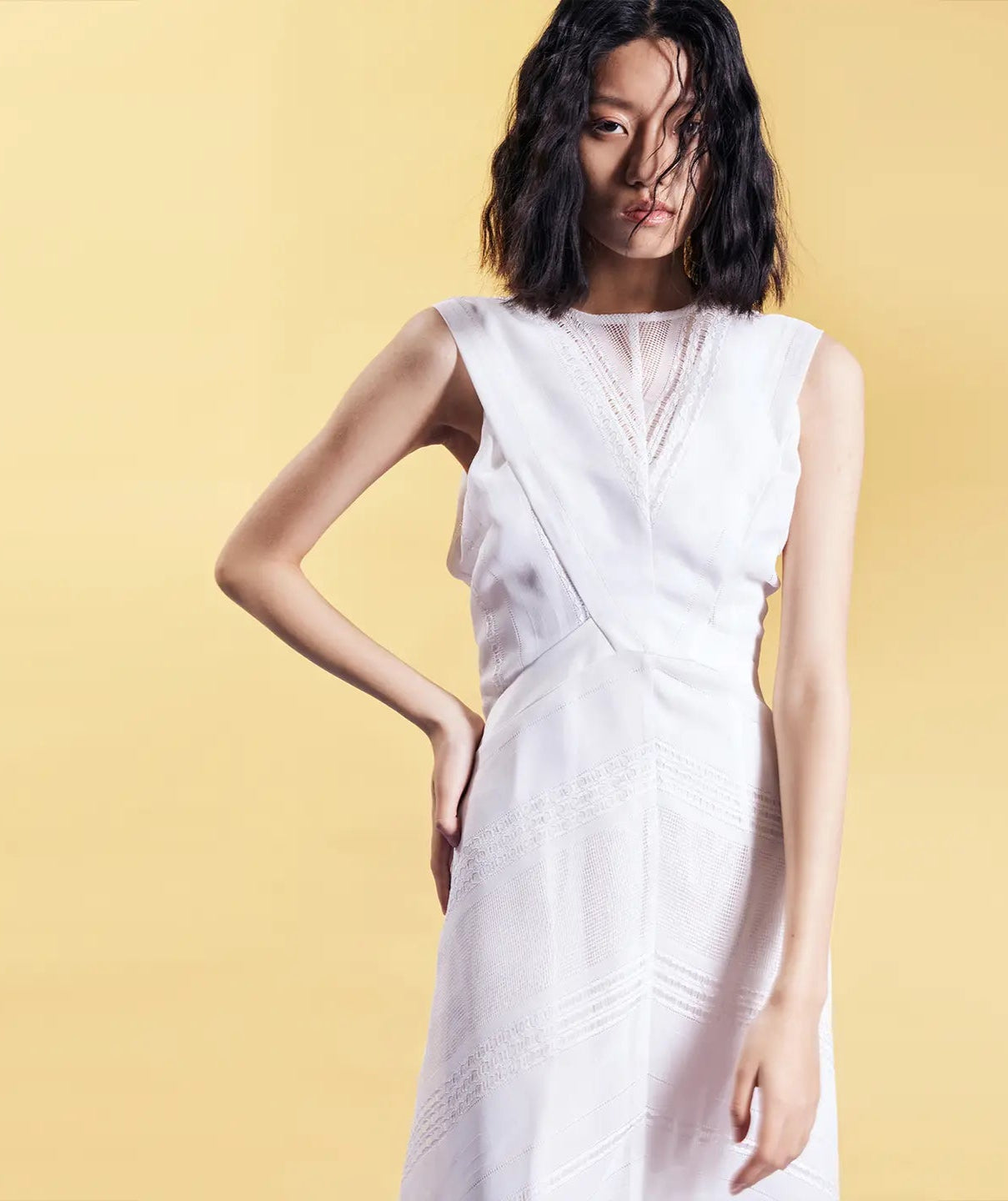 model wearing white sleeveless geometric lace maxi dress