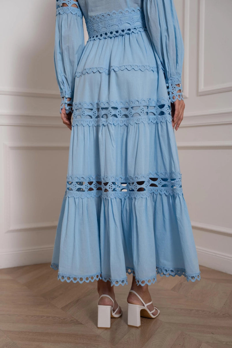 model posing in openwork lace co-ord with flowy maxi skirt and crop shirt