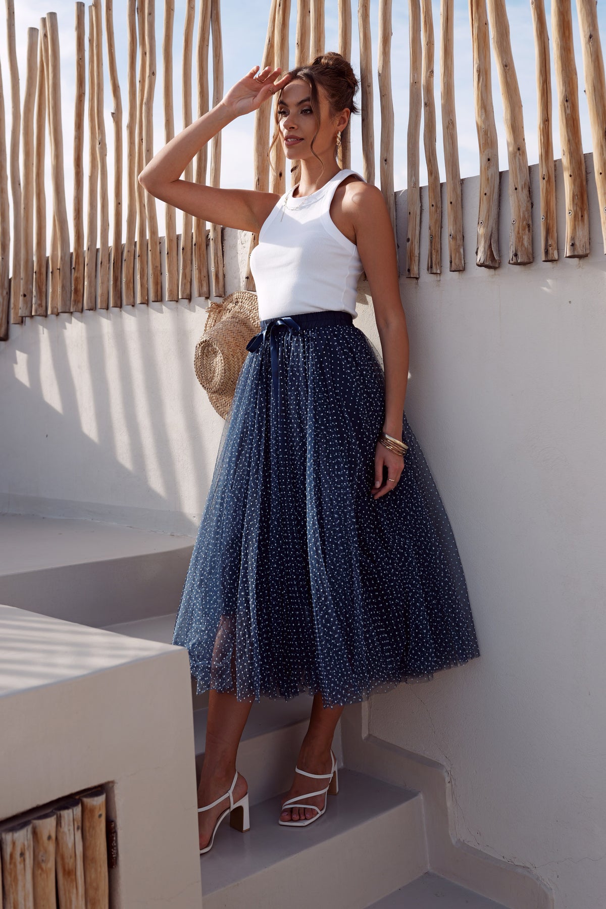 Navy and white polka dot tulle skirt with layered flowing midi length