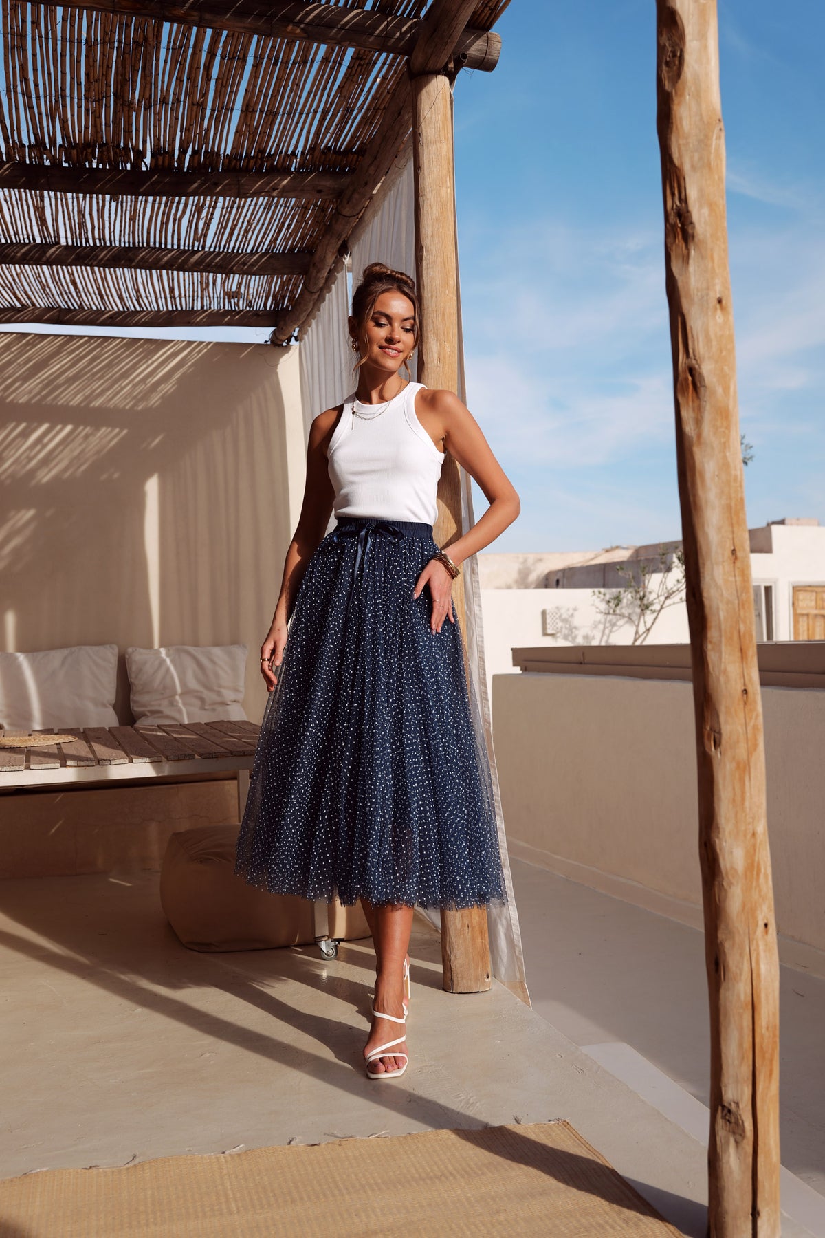 Women’s navy blue tulle midi skirt with white polka dots and full A-line silhouette
