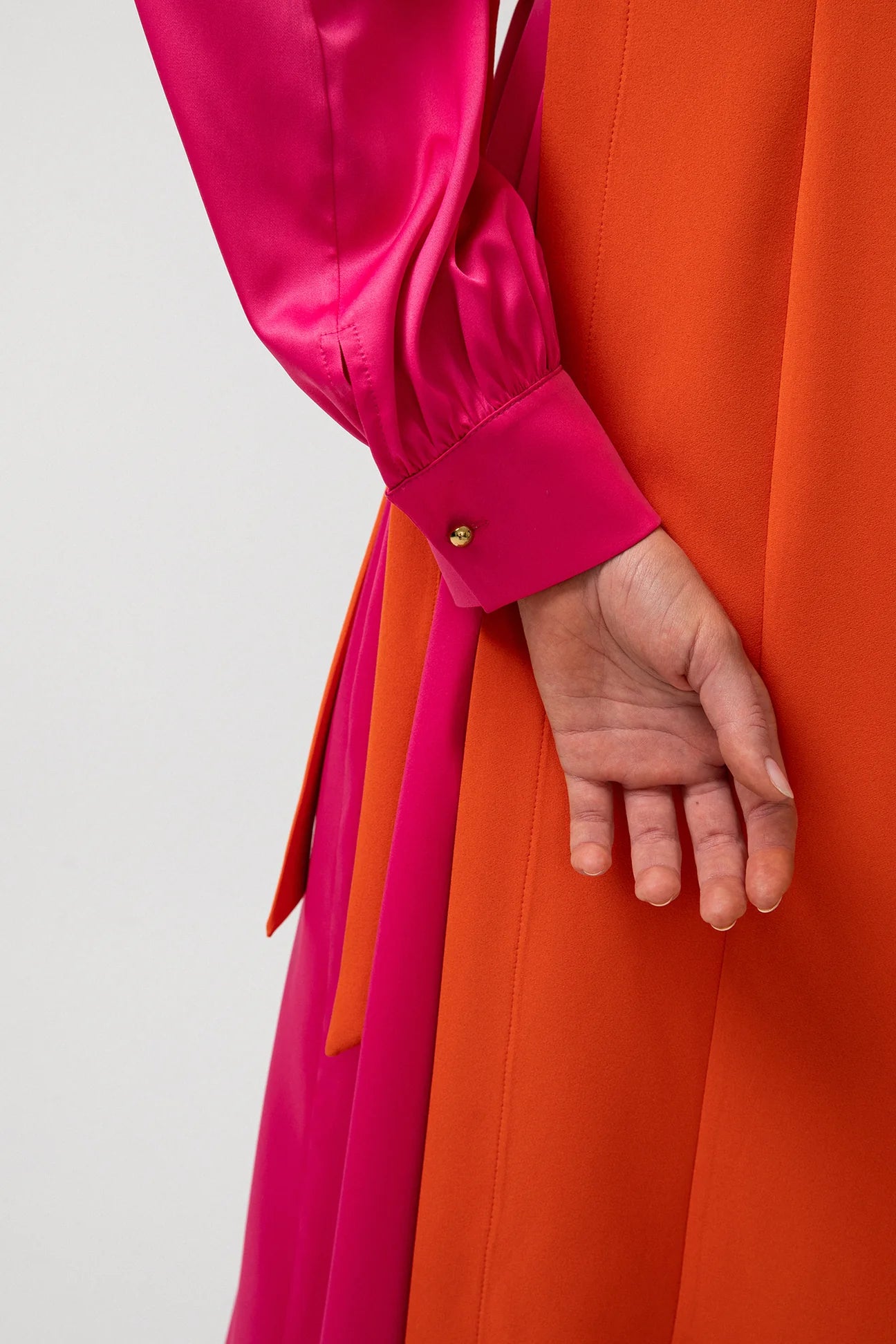 Close-up of waist tie detail on bold colour block party dress