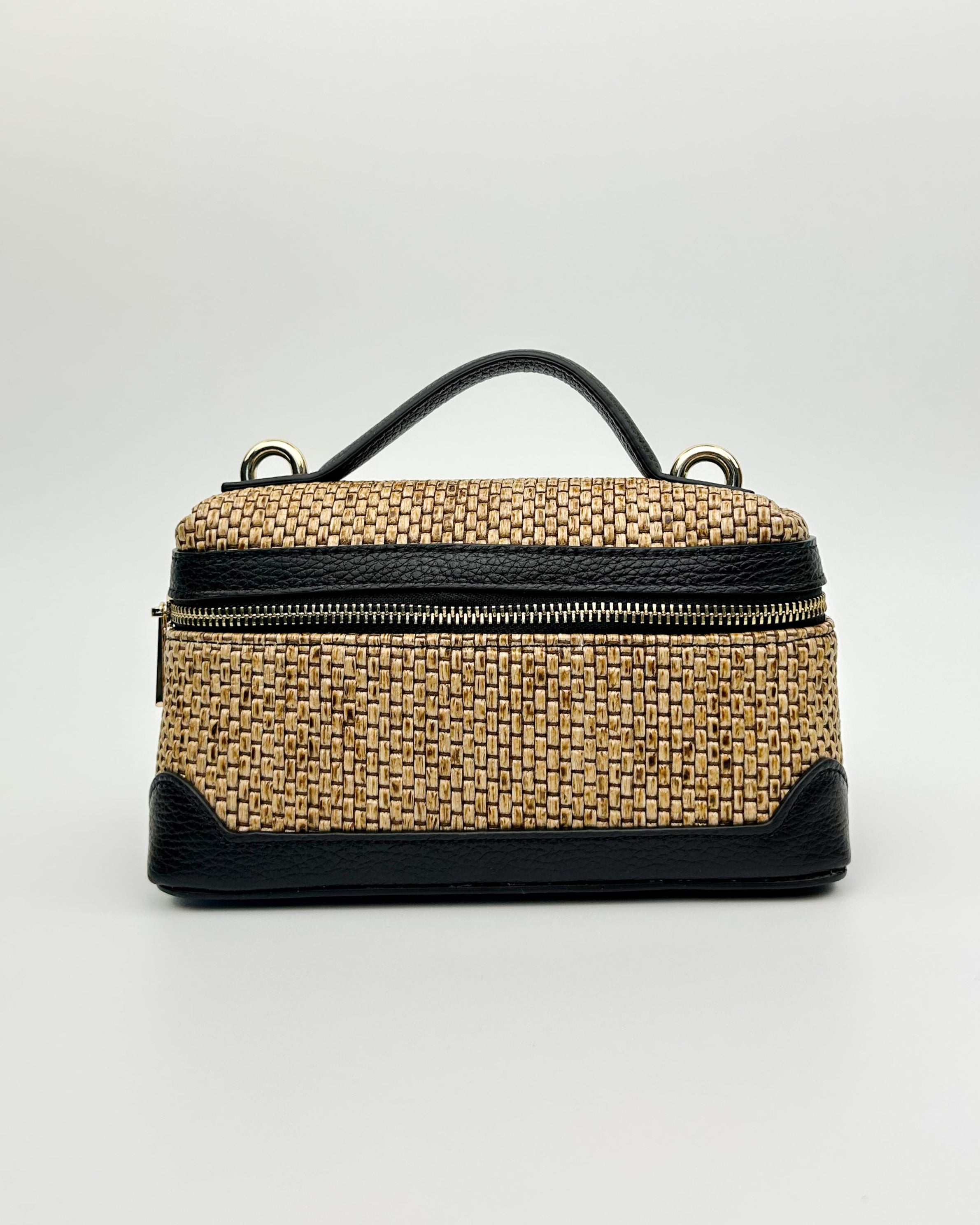 Sofia Vanity Bag made from raffia with black leather detailing, featuring a top handle and shoulder strap