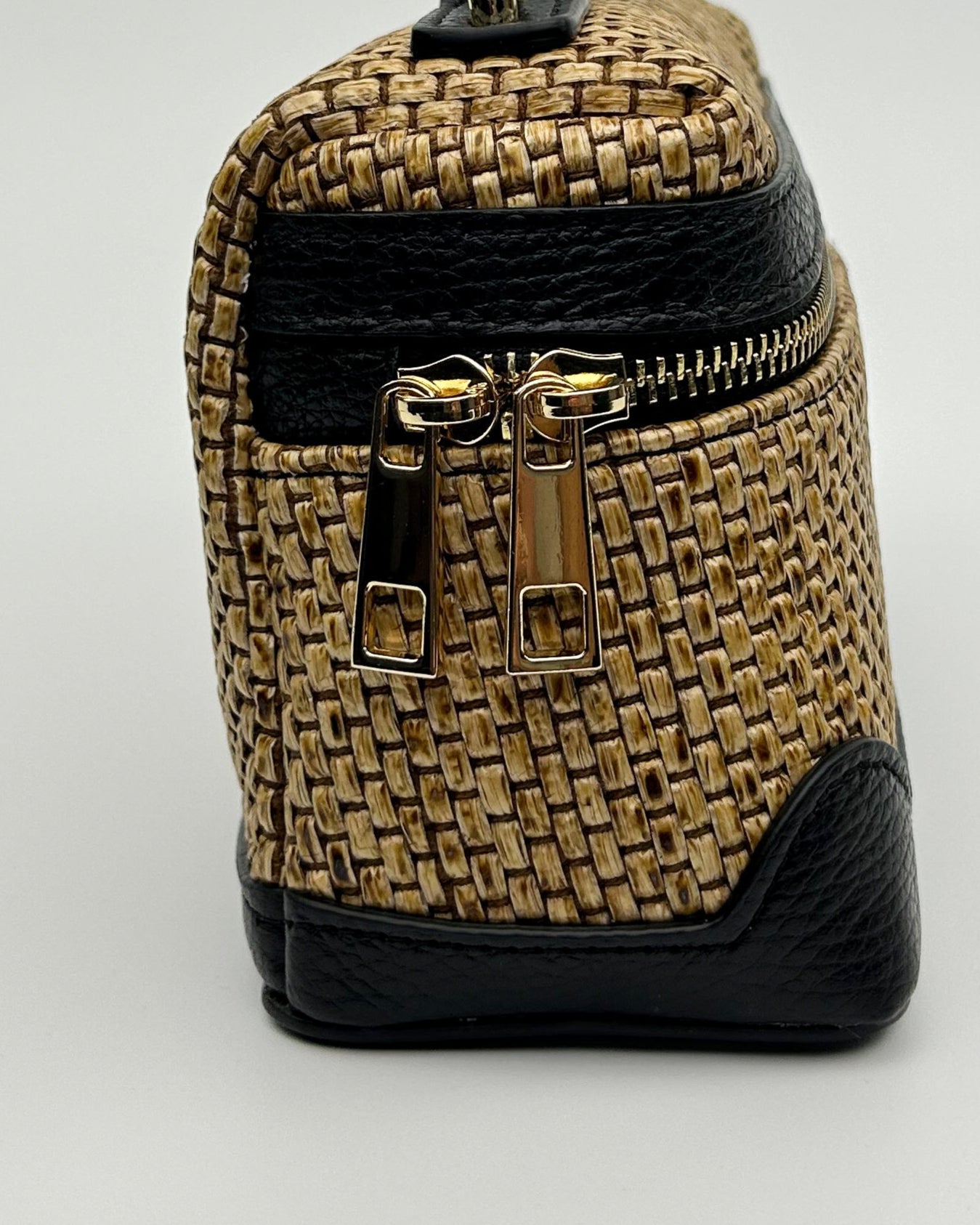 "Chic Sofia Vanity Bag with woven raffia body and smooth black leather trim, styled with dual straps