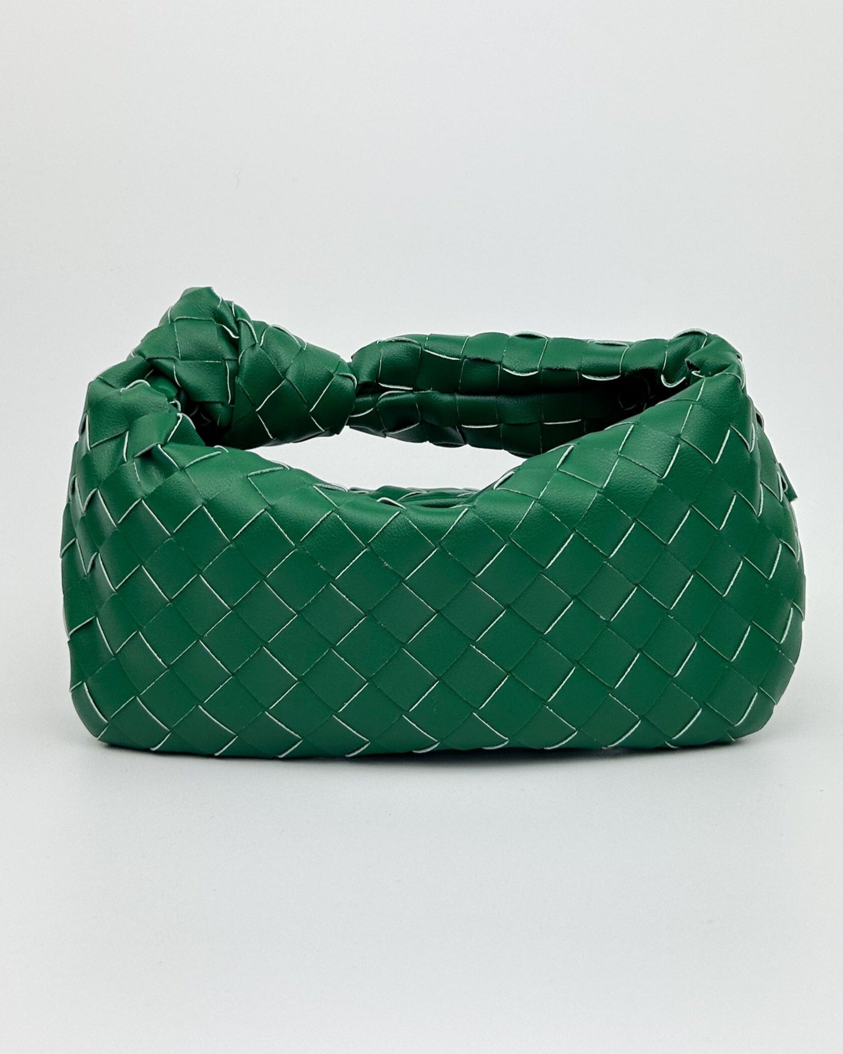 Green Italian leather woven bag with crescent silhouette and knotted top handle – The Knot Woven Bag front view