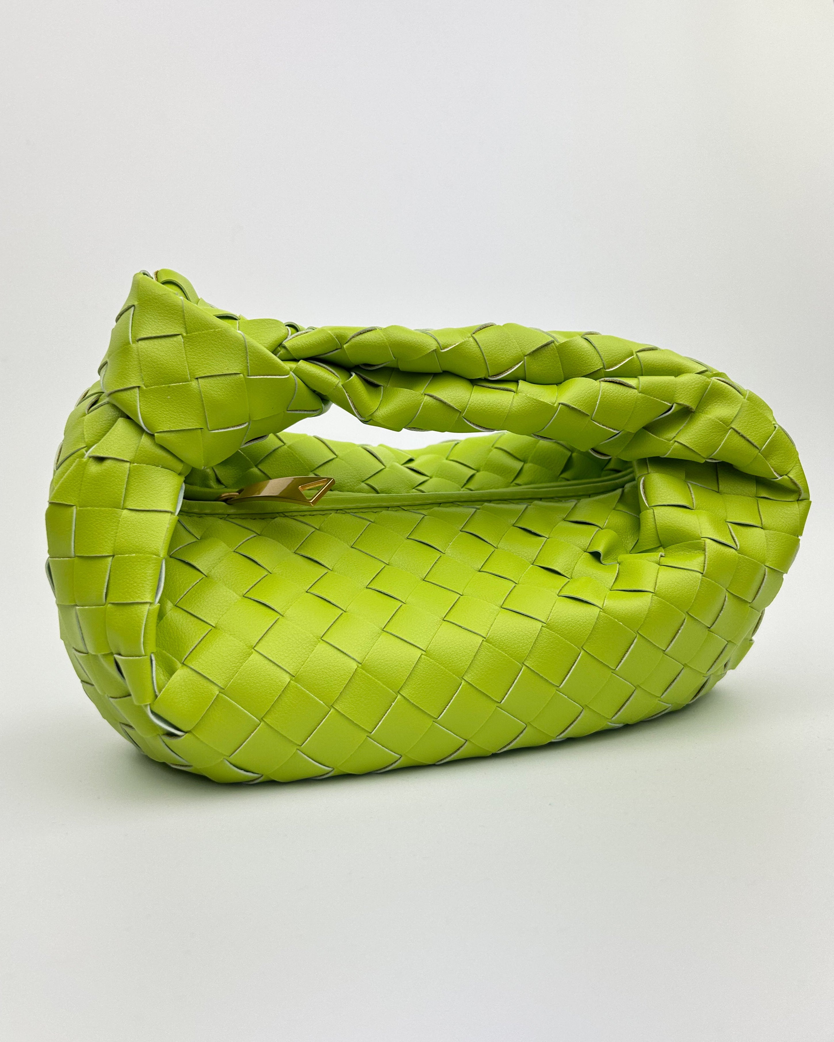 Side view of sculptural lime green leather crescent bag – bold colour handbag made in Italy