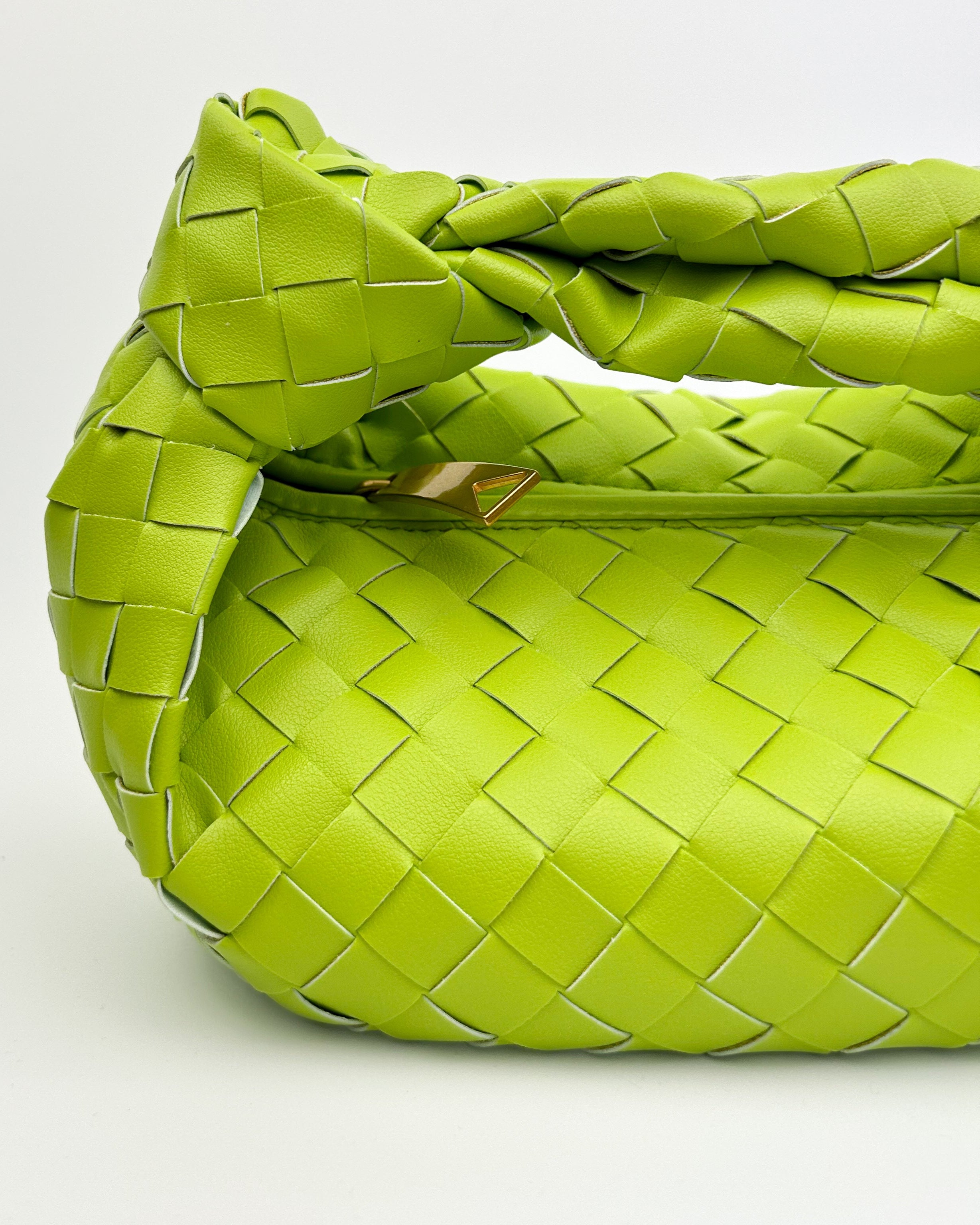Interior of lime green leather woven bag with zip fastening, full lining and internal slip pocket – designer handbag for everyday or events