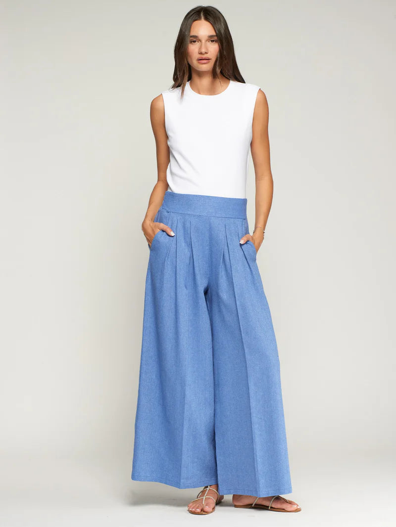 Woman wearing Vilagallo light blue herringbone wide-leg trousers with white top - Spanish designer pleated pants