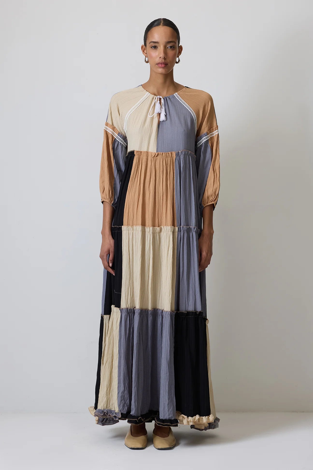 Front view of patchwork boho maxi dress with long gathered sleeves