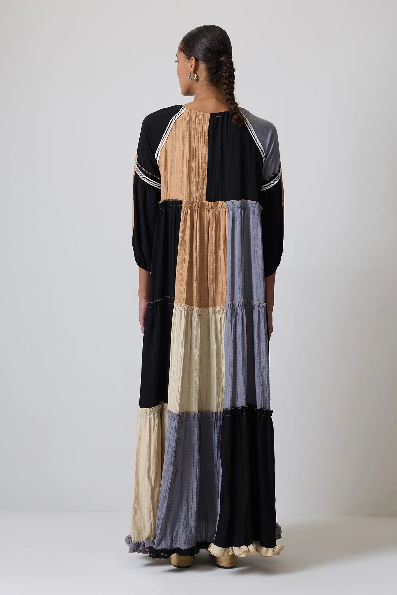Full-length shot of model wearing long sleeve colour block maxi dress