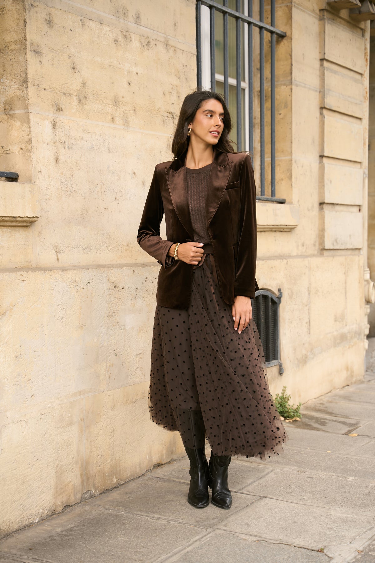 Woman wearing brown polka dot tulle midi skirt with chocolate velvet blazer and black boots