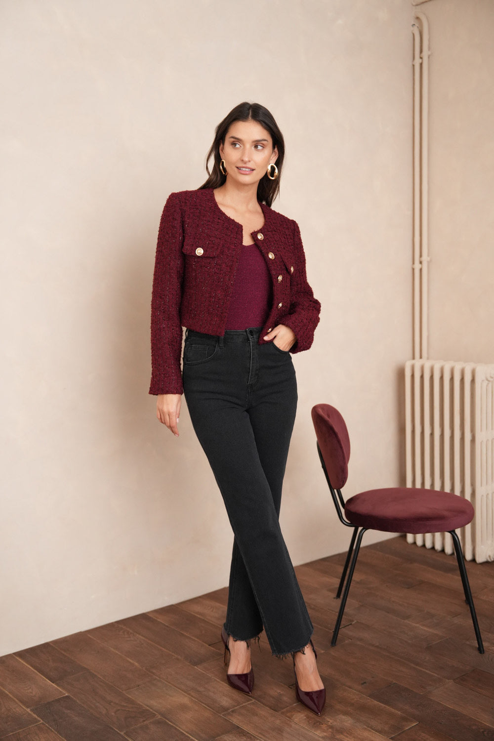 Burgundy tweed blazer detail showing gold button embellishment and chest pockets