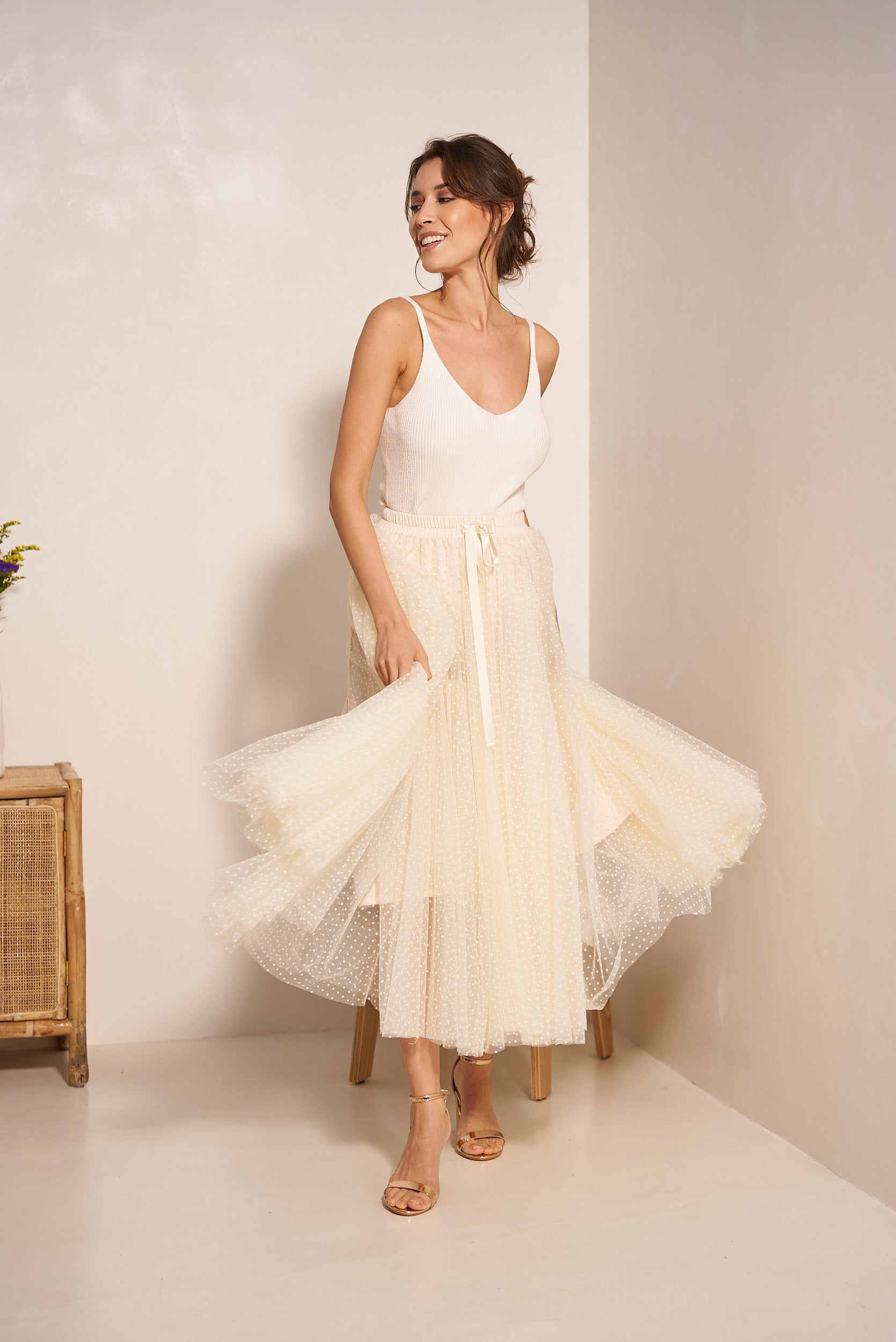 Cream polka dot tulle midi skirt with elasticated waist - front view on model