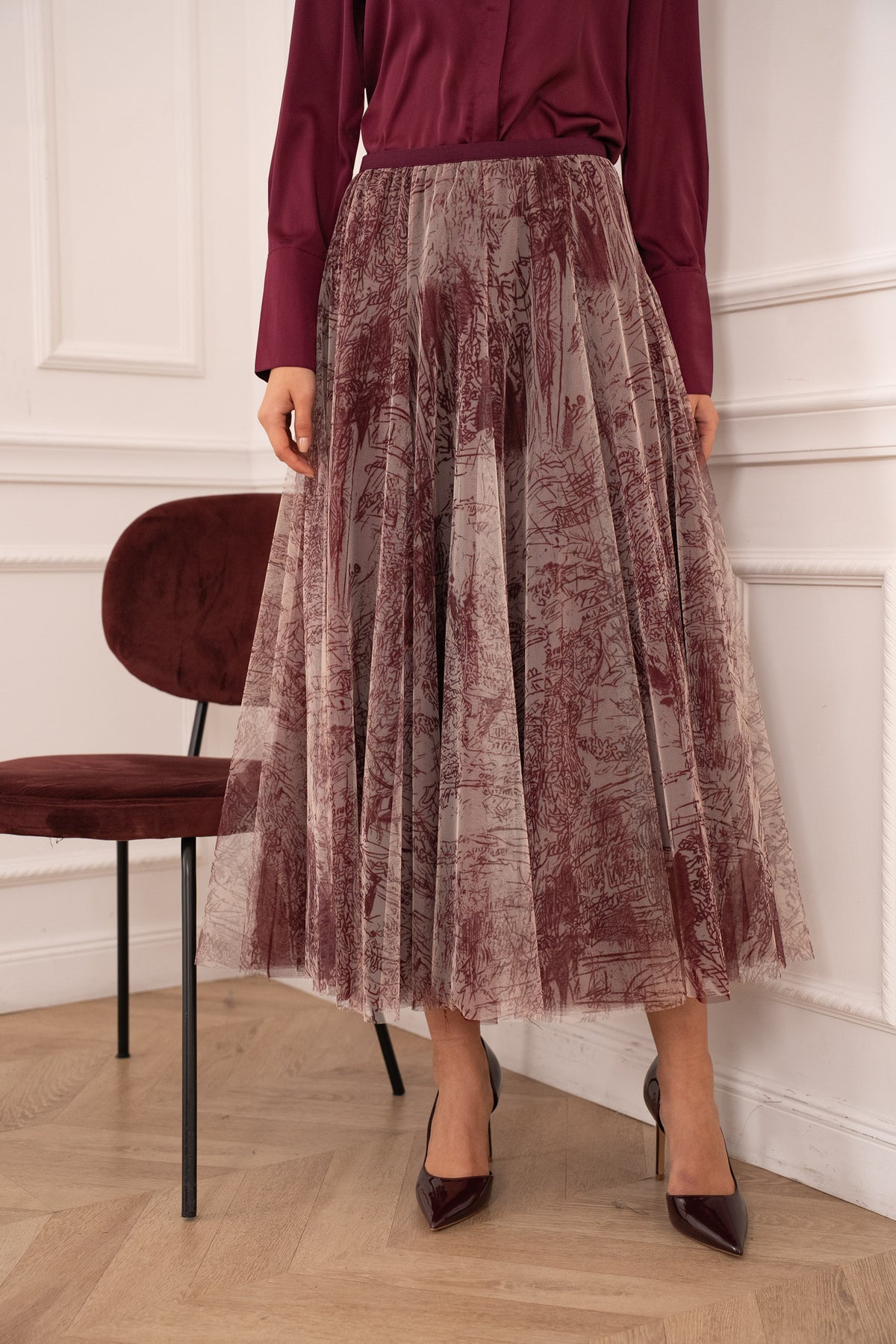 Women’s burgundy and taupe printed tulle midi skirt with soft pleats and flowing silhouette.