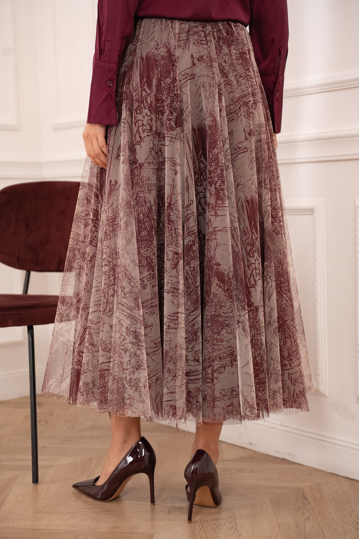 Burgundy printed midi skirt in sheer layered tulle with a feminine A-line shape and fitted waistband.
