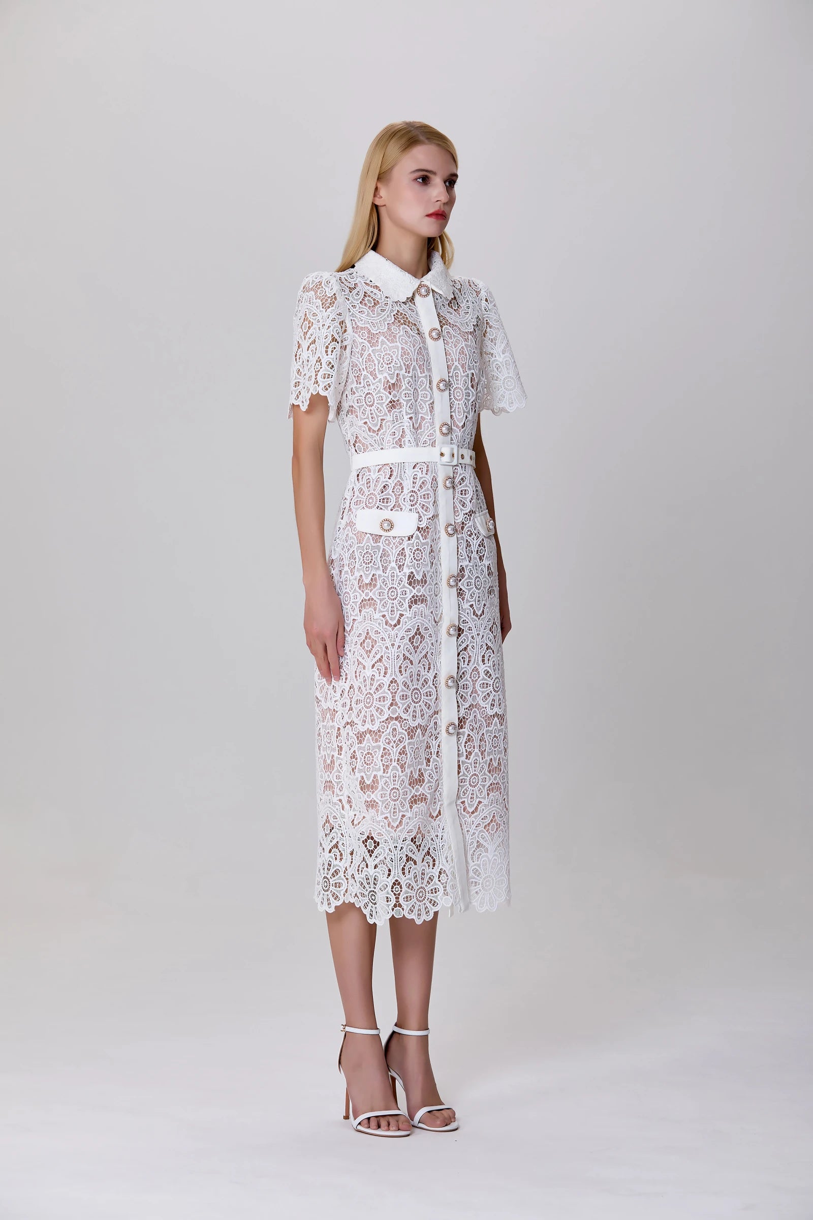 calf-length lace dress with button line and structured silhouette