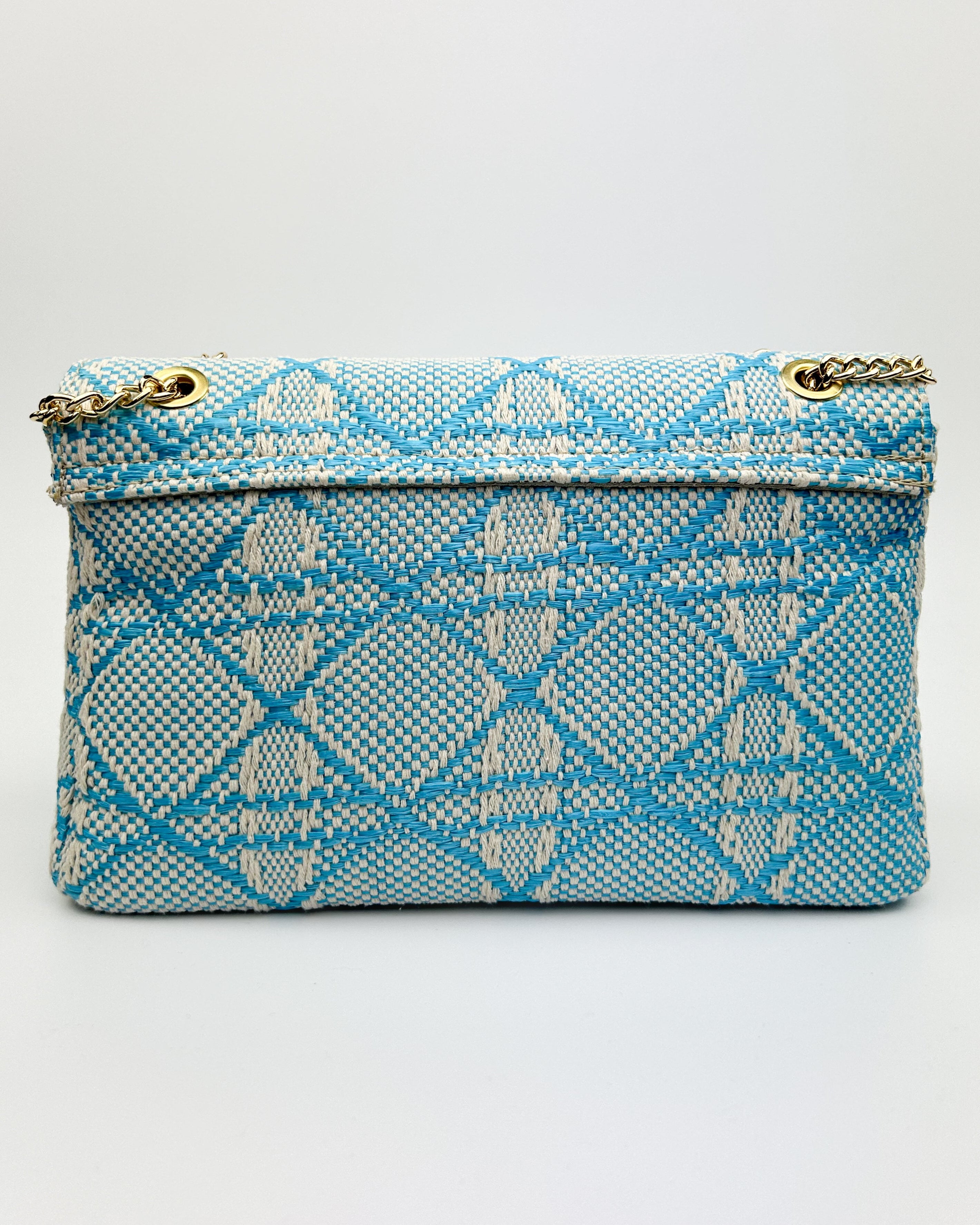 Close-up of Emma bag’s gold chain and leather strap detail