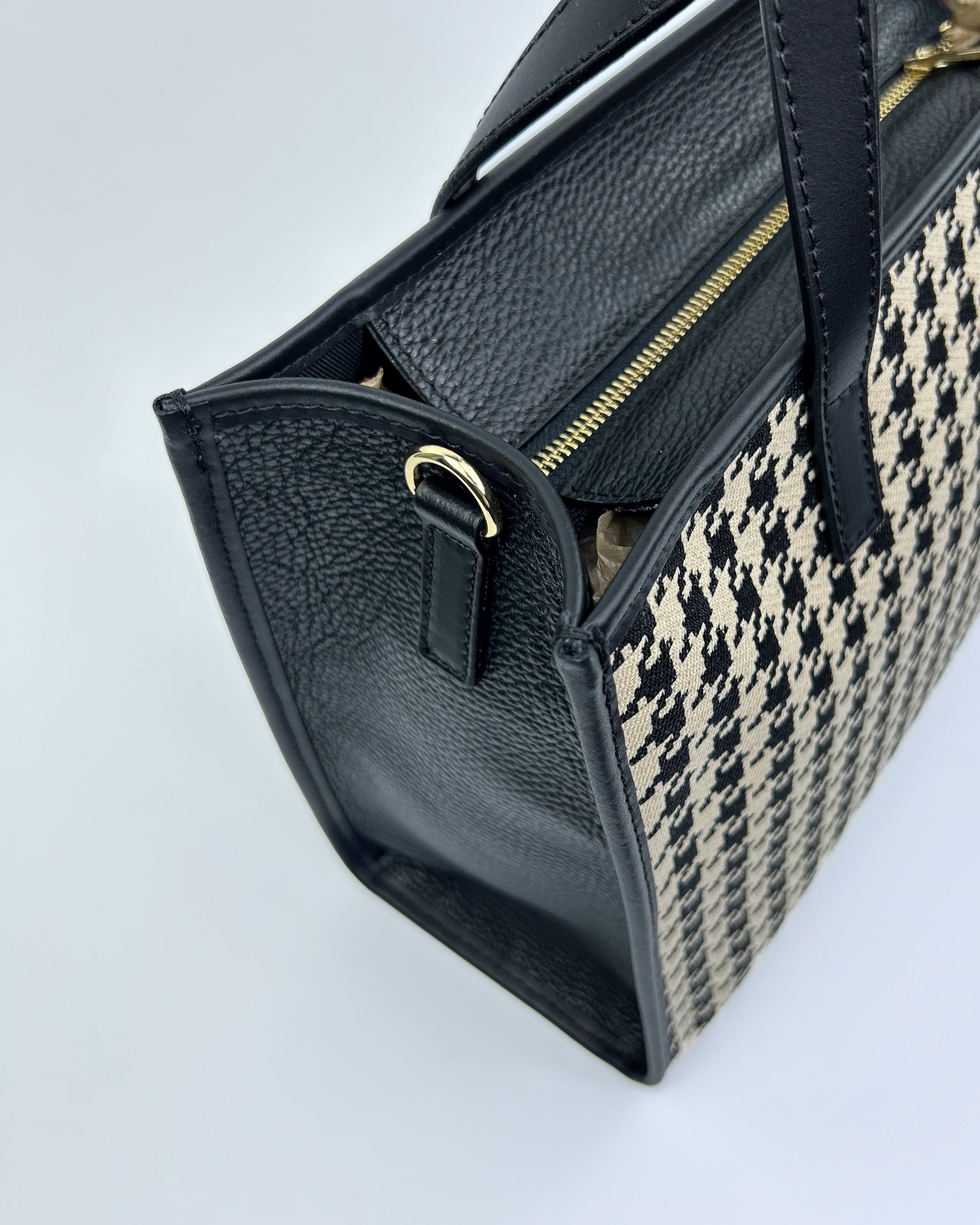 Detail of Emma Tote showing graphic black and white fabric paired with smooth leather