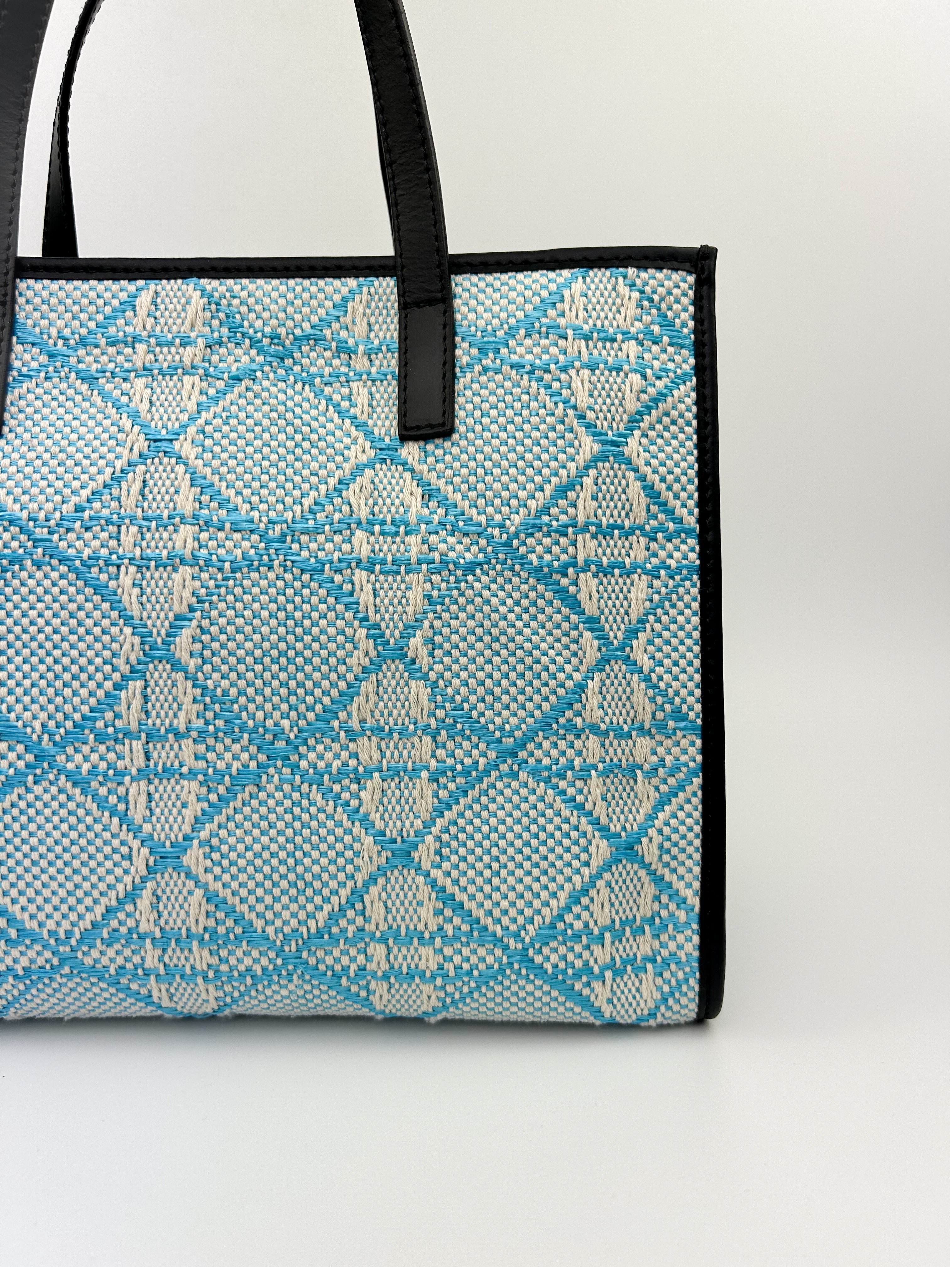 Front angle of blue Emma Tote showcasing textured fabric and leather detailing
