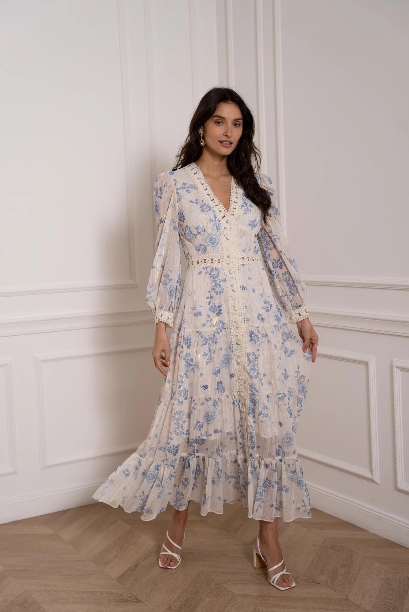 model wearing long floral dress with V-neck and ruffle hem