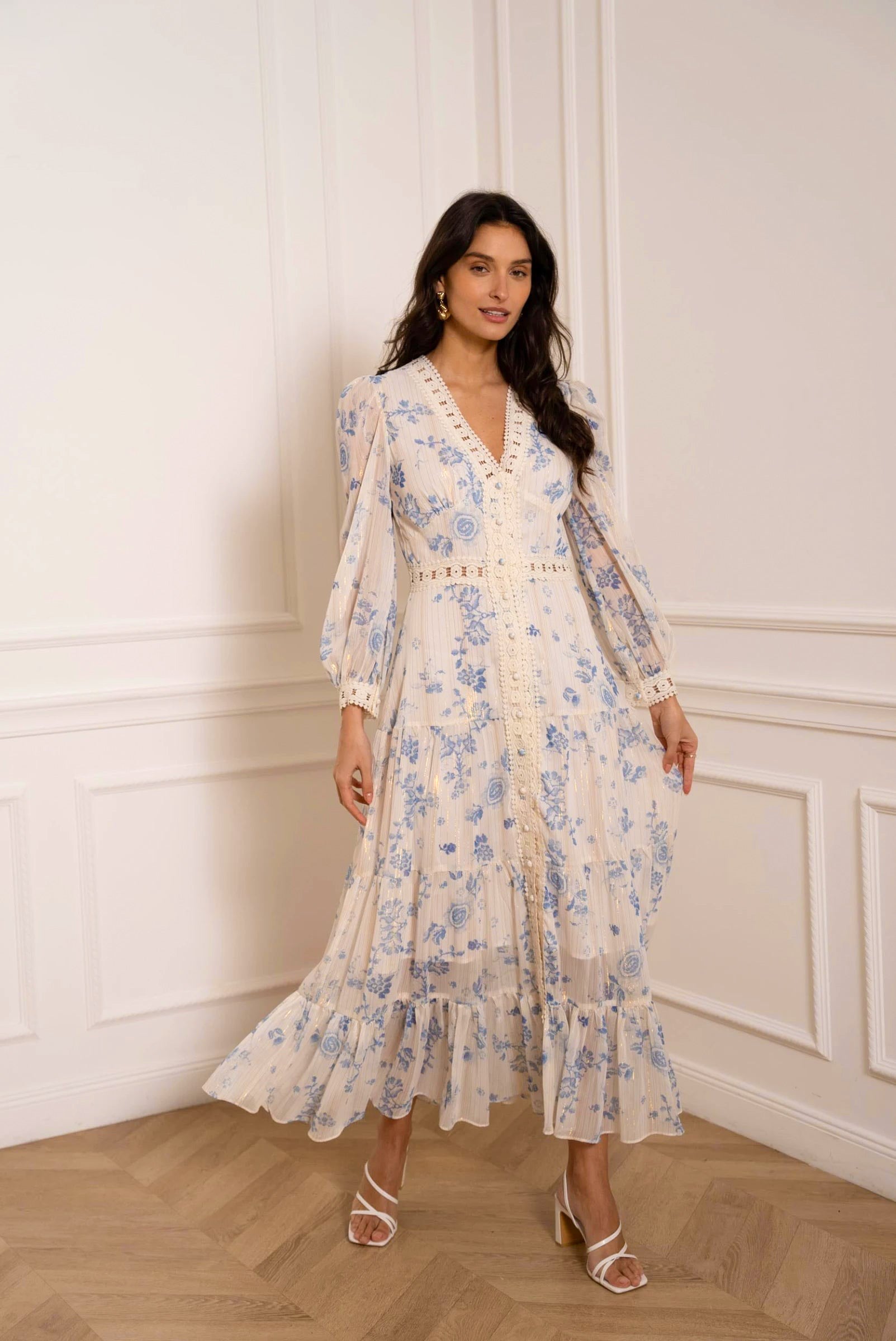 model wearing long floral dress with V-neck and ruffle hem