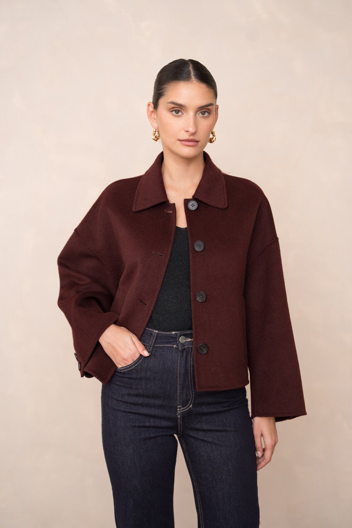 Front view of women’s short wool coat in burgundy – hand-sewn wool blend with buttons.
