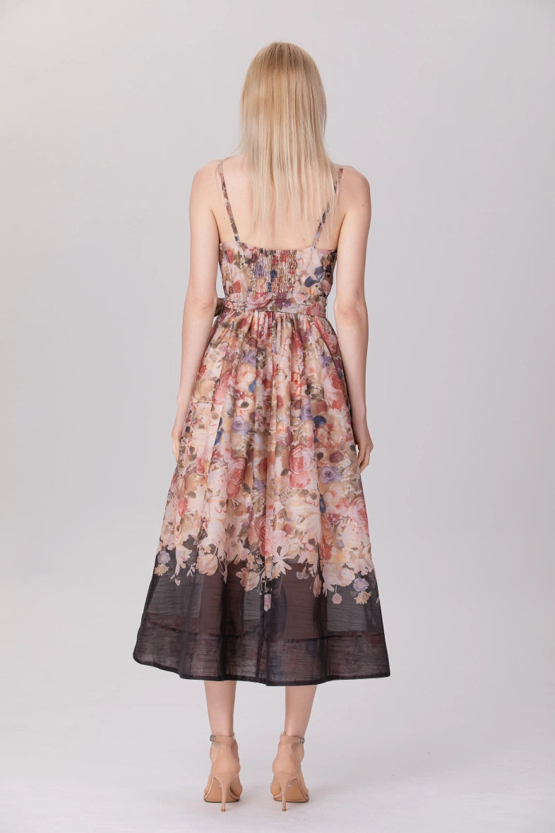 woman wearing sleeveless printed organza dress with heels

