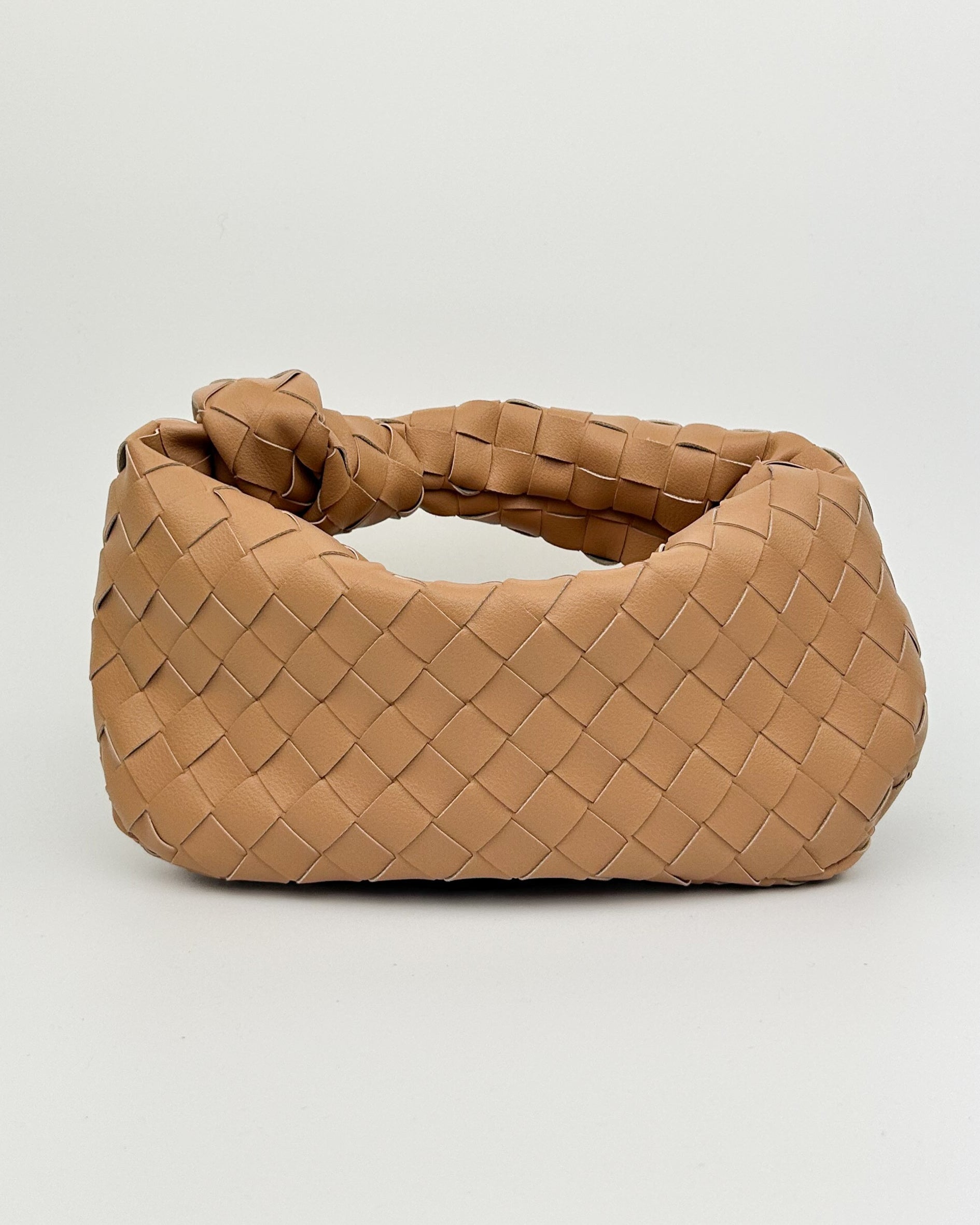 Luxury Italian leather woven handbag with knotted handle, crescent shape, in neutral ecru tone – front view of The Knot Woven Bag