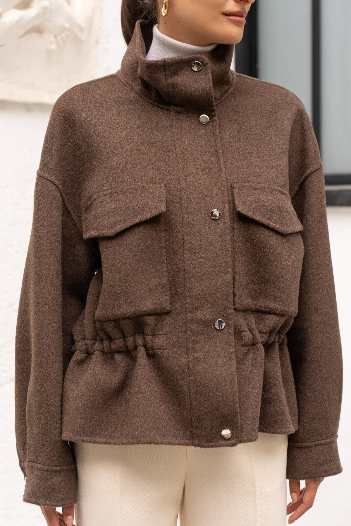 Front view of chocolate wool coat showing zip closure and structured shape.