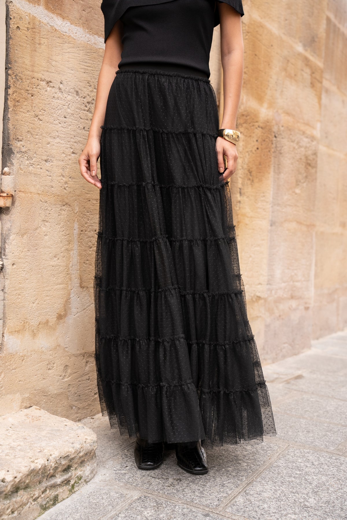 Black tiered tulle maxi skirt with gathered ruffle layers, dotted texture and elasticated waist