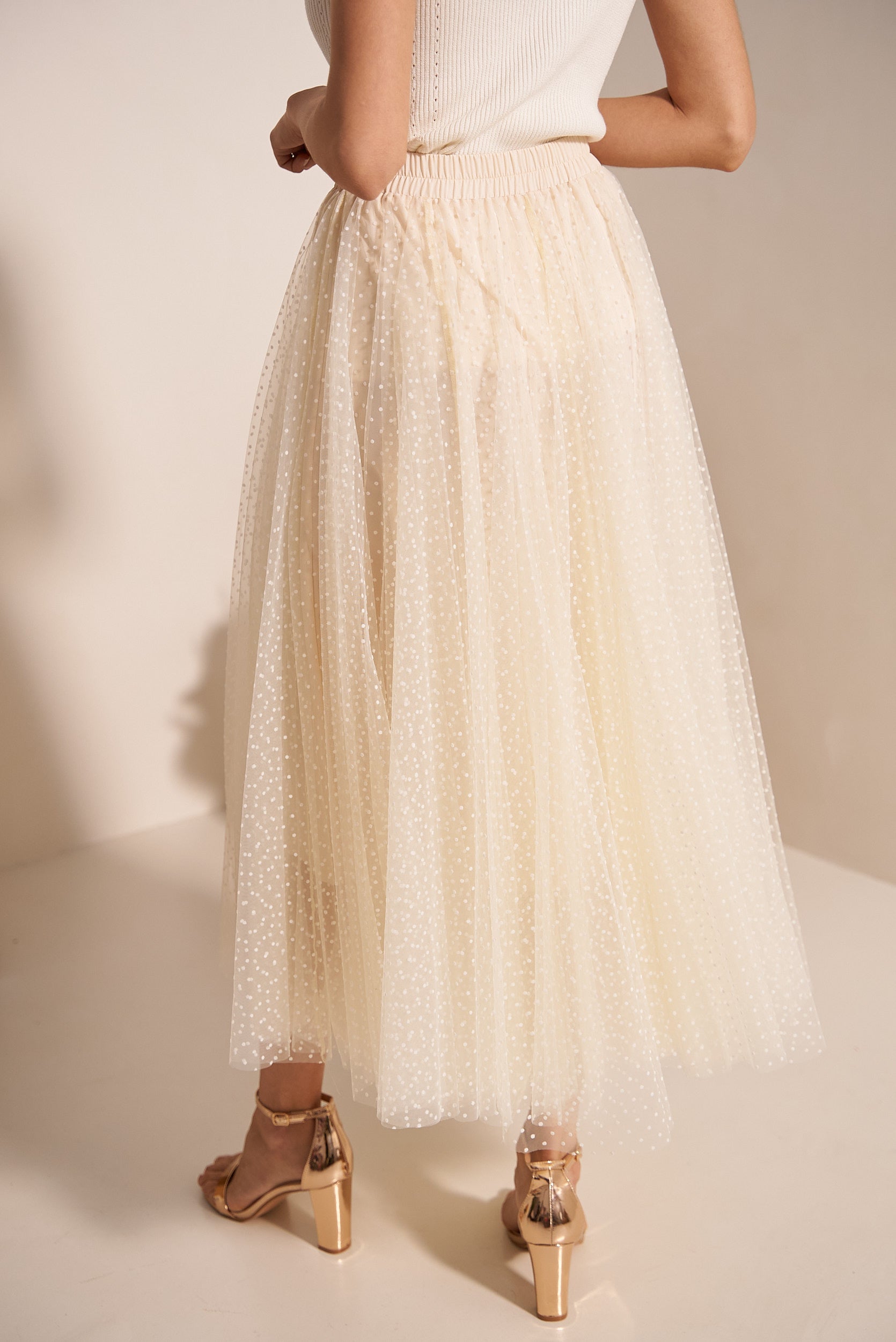 Cream tulle midi skirt detail showing polka dot print and flowing layers