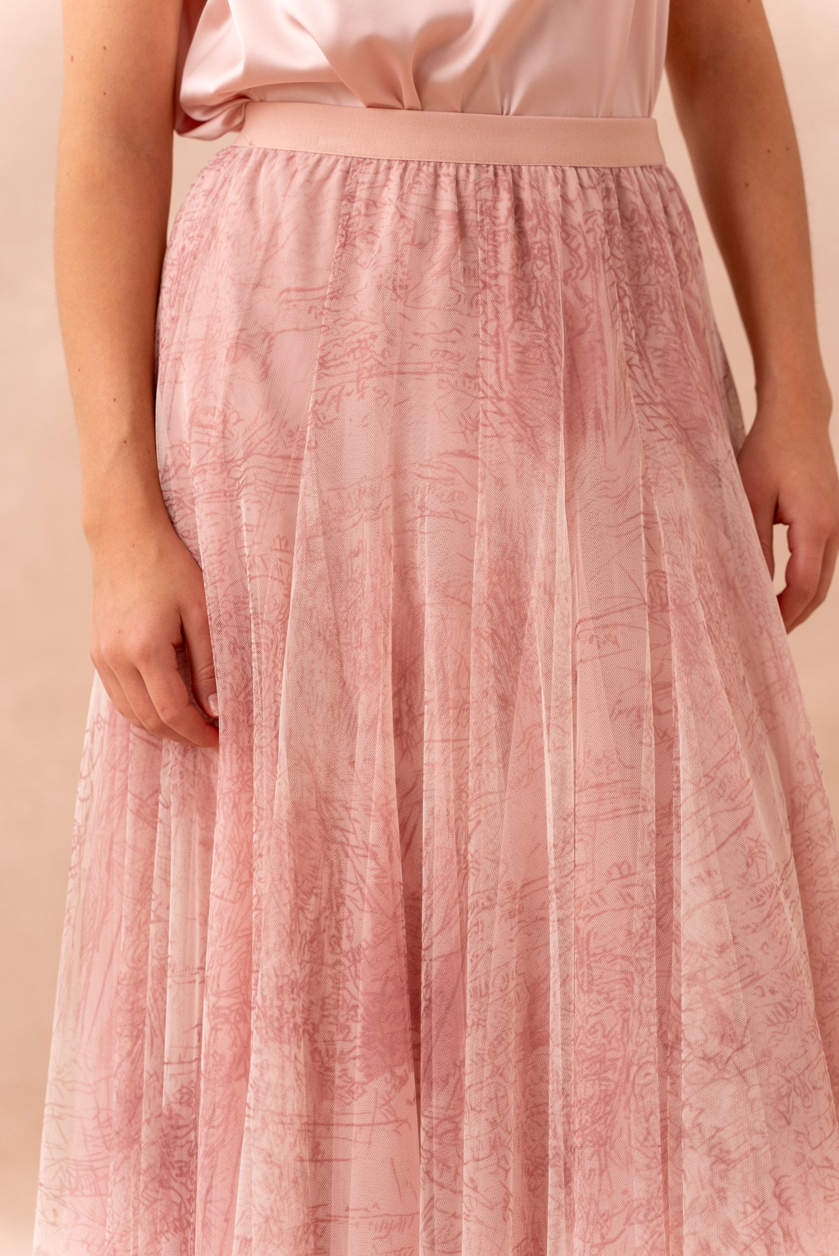 Romantic pink mesh midi skirt styled with satin top and white heels